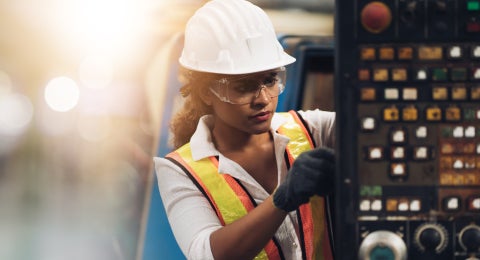 Professional engineer performing a maintenance check in a factory warehouse.