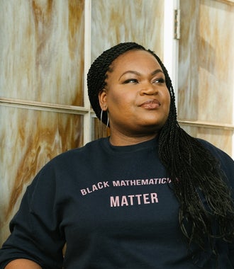 Headshot of Dr. Candice Price wearing a sweatshirt that reads, "Black Mathematicians Matter."